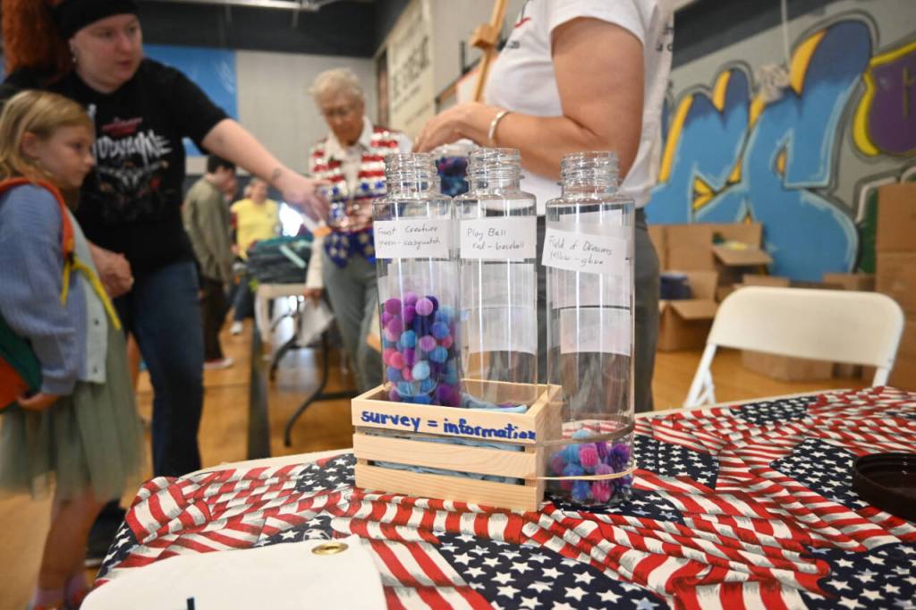 Sequim Gazette photo by Michael Dashiell / League of Women Voters representatives host a poll regarding playground options the City of Sequim is considering, at the Aug. 26 Back to School Fair. Fair attendees were asked to vote on their favorite of three choices; more than two-thirds of the respondents picked Forest Creature, league representatives said.