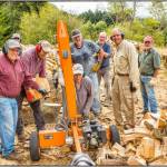 Photo by Bob Lampert / Under the leadership of head woodsman Jack Tatom (center, standing), eight community members spend an early morning on Labor Day (Sept. 4) splitting and chopping wood for donations Path from Poverty, an organization whose goal is to provide drinking water to ladies n Kenya Africa. The group has to date delivered nearly 300 cords of wood in the effort.