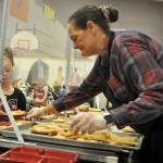 Sequim Gazette photo by Matthew Nash
Heather Conklin, a food service worker at Helen Haller Elementary, serves pizza to students on Sept. 8 during lunch. All Sequim School District students are eligible for free meals during school days under two programs that the district qualified.