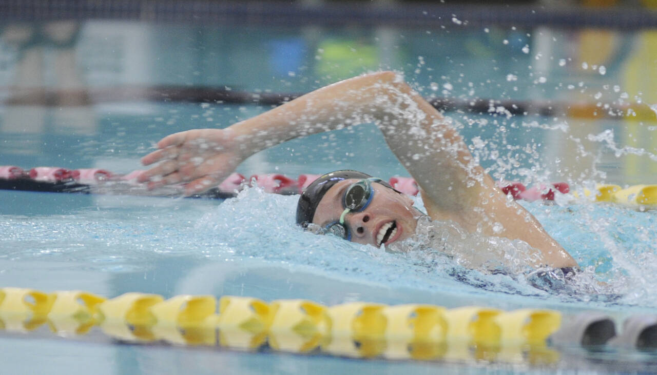 Sequim Gazette photo by Michael Dashiell / Sequims Annie Ellefson races to a win in the 100 freestyle as the Wolves host East Jefferson on Sept. 13. SHS won the season-opener, 86-75.