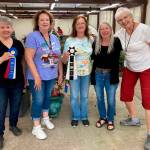 Photo courtesy Sequim Prairie Garden Club/ Celebrating the Floral Barns win for Best Barn at the Clallam County Fair, are, from left, Joan Whiting with the Sequim Prairie Garden Club; Tina Cozzolino, floral barn superintendent; Della LaCour with the Garden Club; Ellen Castleman with the Garden Club, and Patricia Wheatly, assistant floral barn superintendent.