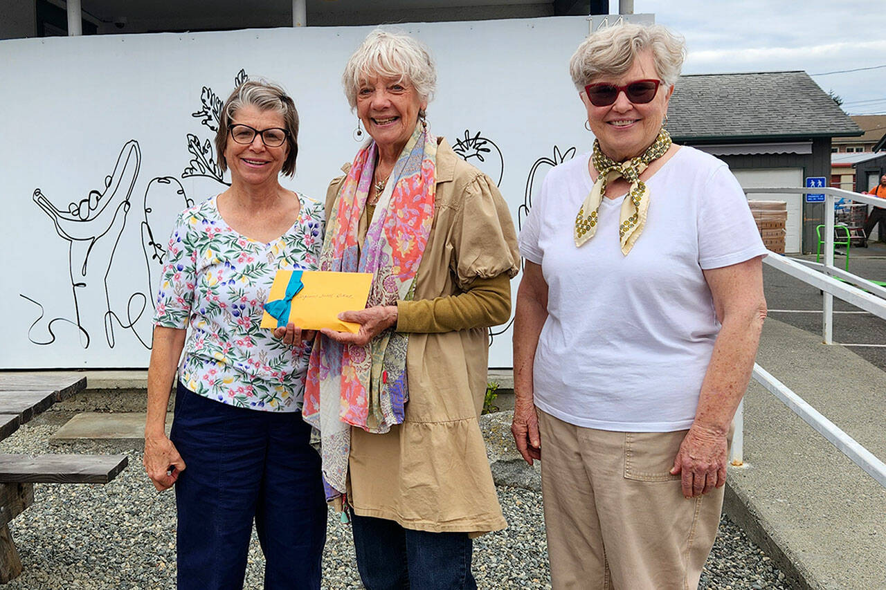 Photo courtesy Susan Gansert Shaw
Susan Gansert Shaw, pictured in middle, and Mary Franchini, on right, with Rock Hollow Arts made a $1,910 donation last week to Pam Wennerberg, Sequim Food Bank operations support specialist.