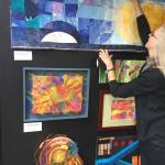 Photo courtesy of Kathie Cook /  Sequim artist Kathie Cook hangs her art quilt, “Arctic Illumination,” in the new Peninsula Fiber Artists exhibit at 675 Tyler St. in uptown Port Townsend.