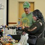 Sequim Gazette photo by Matthew Nash/ Kevin Shea and Reign Mayhem of Port Angeles look at a toy guillotine at the Olympic Peninsula Toy and Collectibles Show on Sept. 9. Shea said he came looking for Lego and saw more cool stuff than he thought, including the guillotine.