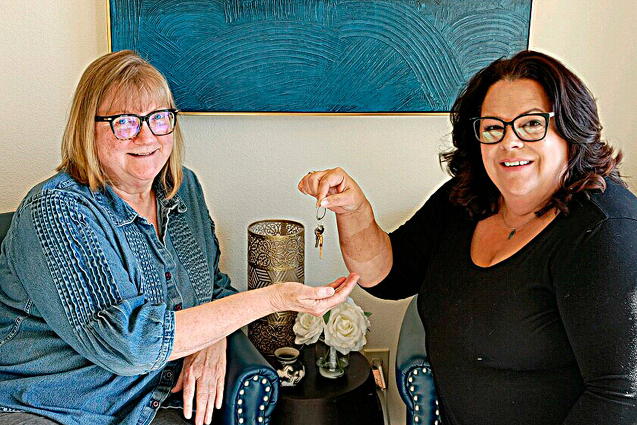 Photo courtesy Sequim Irrigation Festival
Vickie Maples, left, accepts the ceremonial keys to the Sequim Irrigation Festival from Deon Kapetan as Maples becomes the new executive director for the festival going into its 129th year. Kapetan has served in various volunteer roles since 1999 including as executive director.