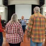 Sequim Gazette photo by Emily Matthiessen / Director Linda Muldowney leads the Juan de Fuca Harmony chorus in song as they prepare for their 40th anniversary concert. Muldowney has been directing the chorus since 2018.