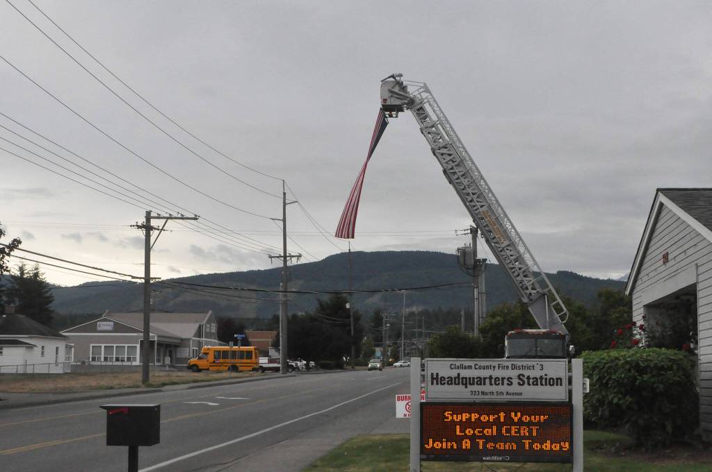 Sequim Gazette photo by Matthew Nash
A fire truck on Fifth Avenue displays an American flag on the 22nd anniversary of the 9/11 terrorist attacks.