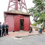 Port Townsend Police Officer Jon Stuart, Chief Thomas Olson, Assistant Fire Chief Brian Tracer and Fire Chief Bret Black observe a moment of silence Monday as Jefferson County Sheriff Joe Nole reads a remembrance of the terrorist attacks on the World Trade Center in New York on Sept. 11, 2001. (Steve Mullensky/for Peninsula Daily News)