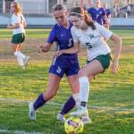 Sequims Ivy Barrett, left, and Port Angeles Kedryn DeScala battle for possession in an Olympic League match-up on Sept. 14 in Sequim. Barretts Wolves won the rivalry game, 2-1.
