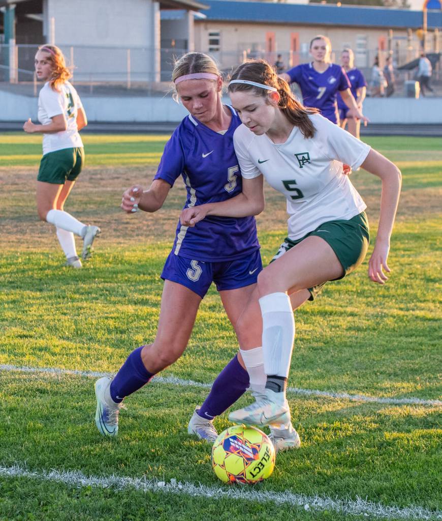 Sequims Ivy Barrett, left, and Port Angeles Kedryn DeScala battle for possession in an Olympic League match-up on Sept. 14 in Sequim. Barretts Wolves won the rivalry game, 2-1.