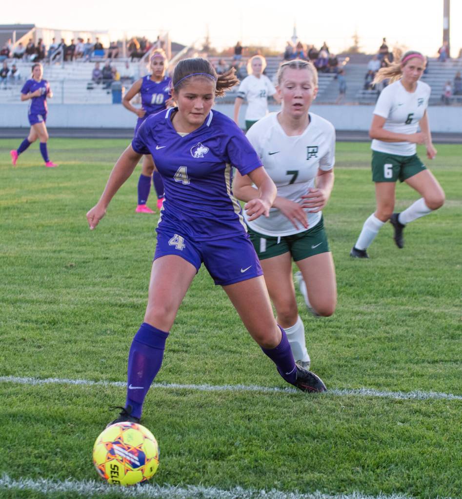 Sequim Gazette photo by Emily Matthiessen
Sequims Raimey Brewer, left gains possession as Port Angeles Izzy Felton pursues the play in a Sept. 14 Olympic League match-up in Sequim. The host Wolves won, 2-1.