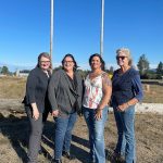 Sequim Gazette photo by Matthew Nash
To commemorate the Sequim Logging Show becoming its own 501(c)(4) nonprofit organization, organizers of the Sequim Irrigation Festival and show gather on the Blake Property, south of Carrie Blake Community Park, where the event continues May 10-11, 2024, the second weekend of the festival. From left, festival executive director Vickie Maples, past festival executive director Deon Kapetan, Logging Show co-director Shellie Torrence, and logging show volunteer Trish Bekkevar all said the transition will be seamless and the decision was made for insurance reasons.