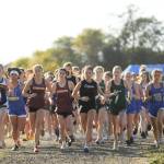 Sequim Gazette photo by Michael Dashiell / Competitors in a combined varsity-junior varsity girls race break from the starting line at an Olympic League meet in Sequim on Sept. 20.