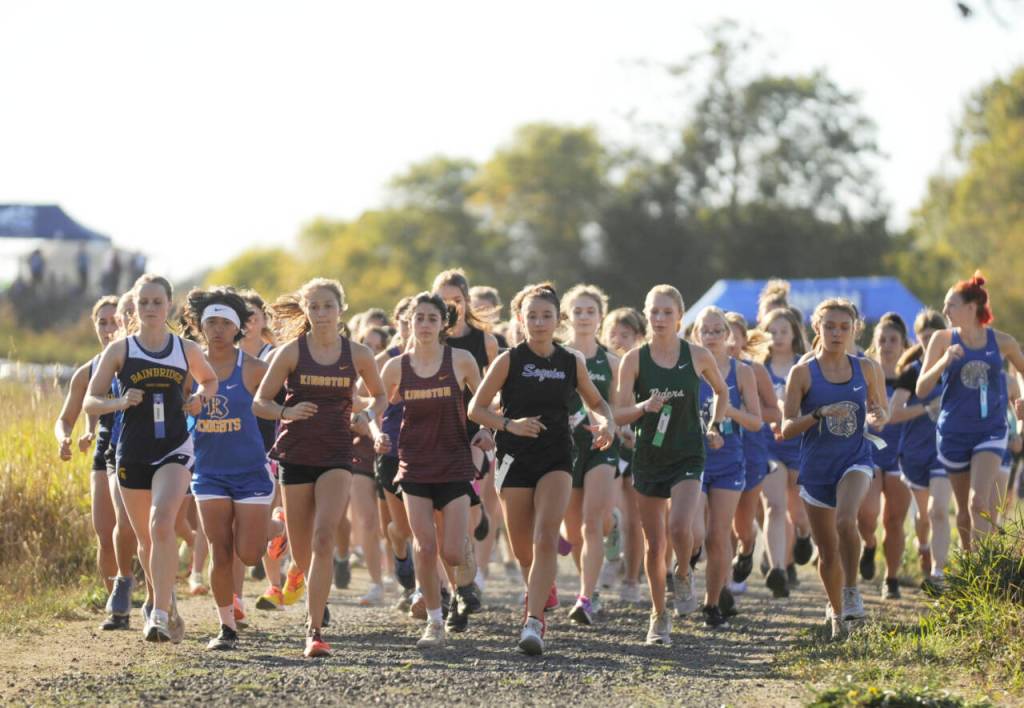 Sequim Gazette photo by Michael Dashiell / Competitors in a combined varsity-junior varsity girls race break from the starting line at an Olympic League meet in Sequim on Sept. 20.