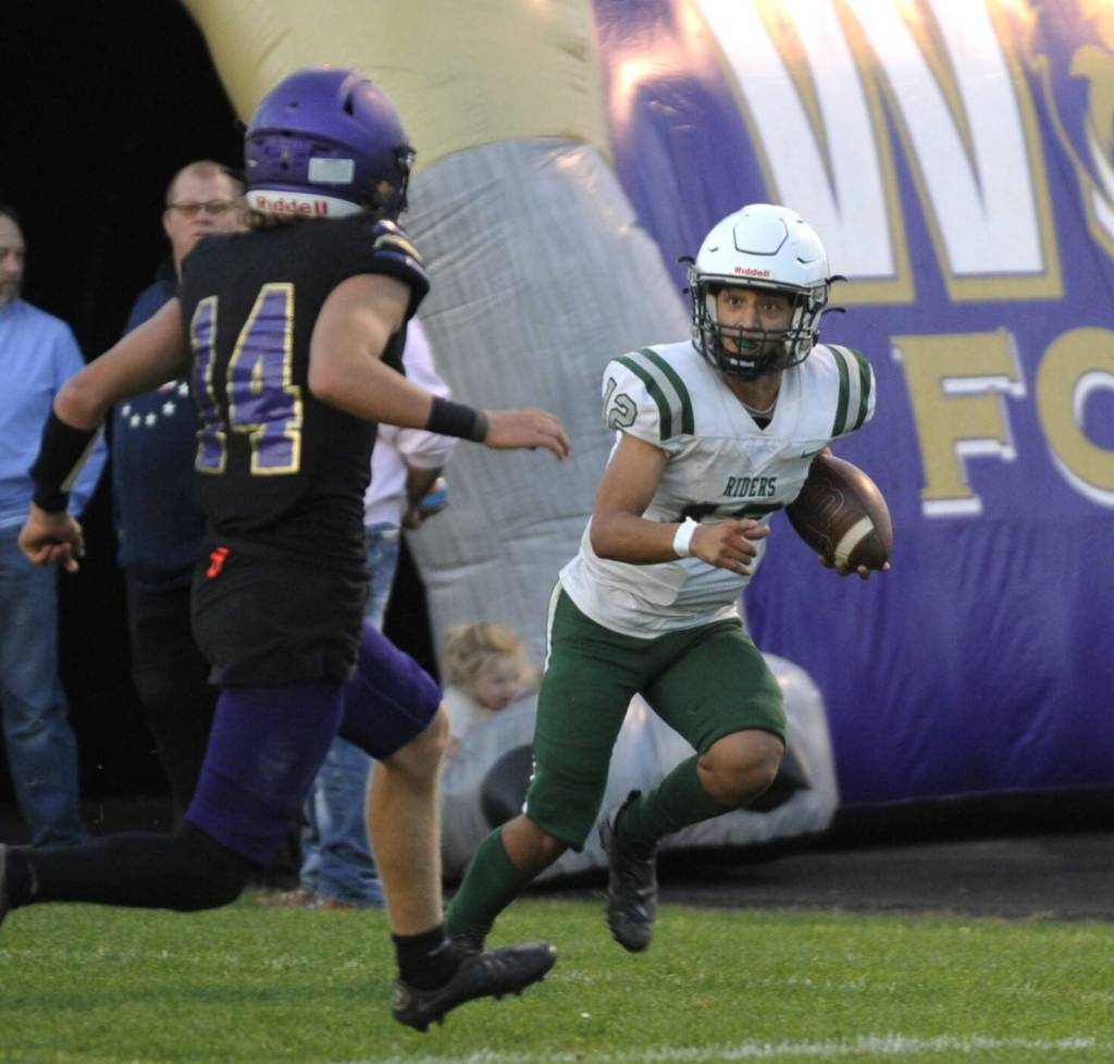 Sequim Gazette photo by Michael Dashiell / Port Angeles Kason Albough, right, evades the tackle of Sequims Zeke Schmadeke to score the Roughriders first touchdown in a 37-10 Rainshadow Rumble victory in Sequim on Sept. 22.