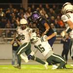 Sequim Gazette photo by Michael Dashiell / A meeting of quarterbacks: Sequims Lars Wiker gains a first down as hes tackled by Port Angeles Parker Nickerson late in the fourth quarter of PAs 37-10 Raindshadow Rumble victory in Sequin=m on Sept. 22.
