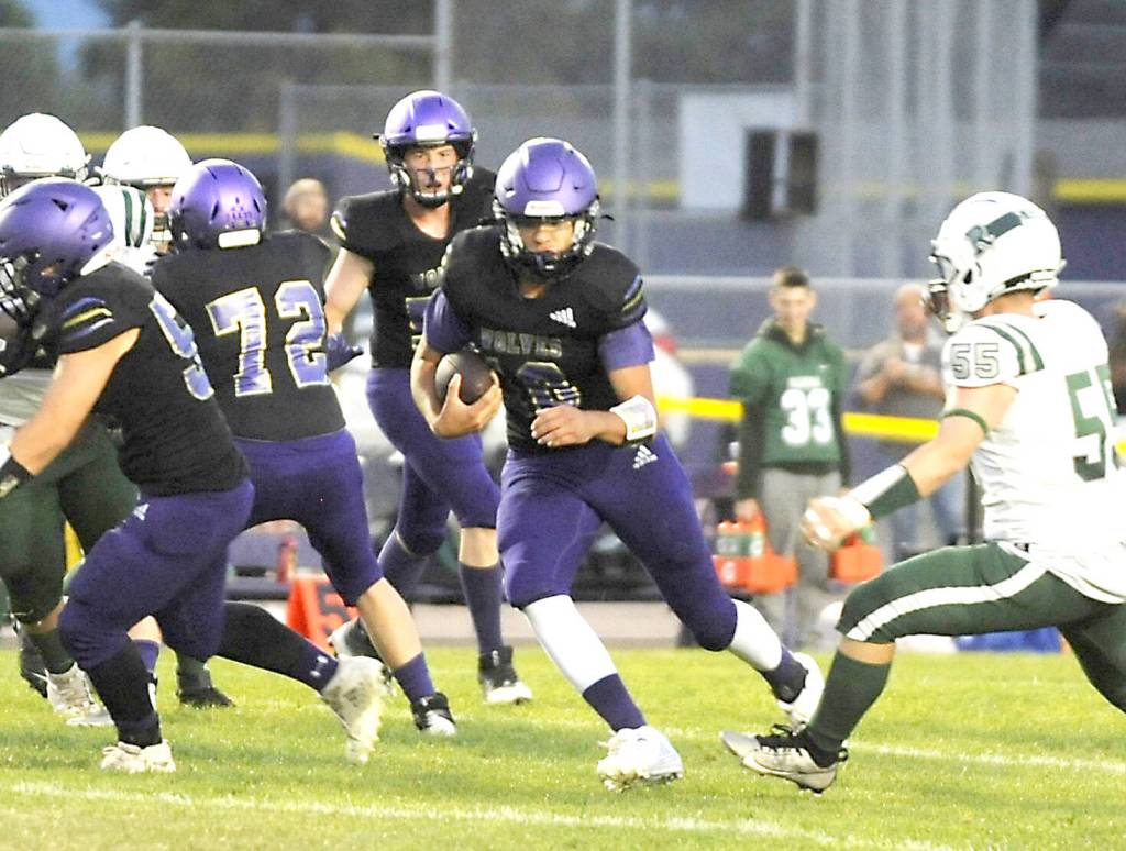 Sequim Gazette photo by Michael Dashiell
Sequim quarterback Lars Wiker (10) looks for running room against Port Angeles on Friday night.