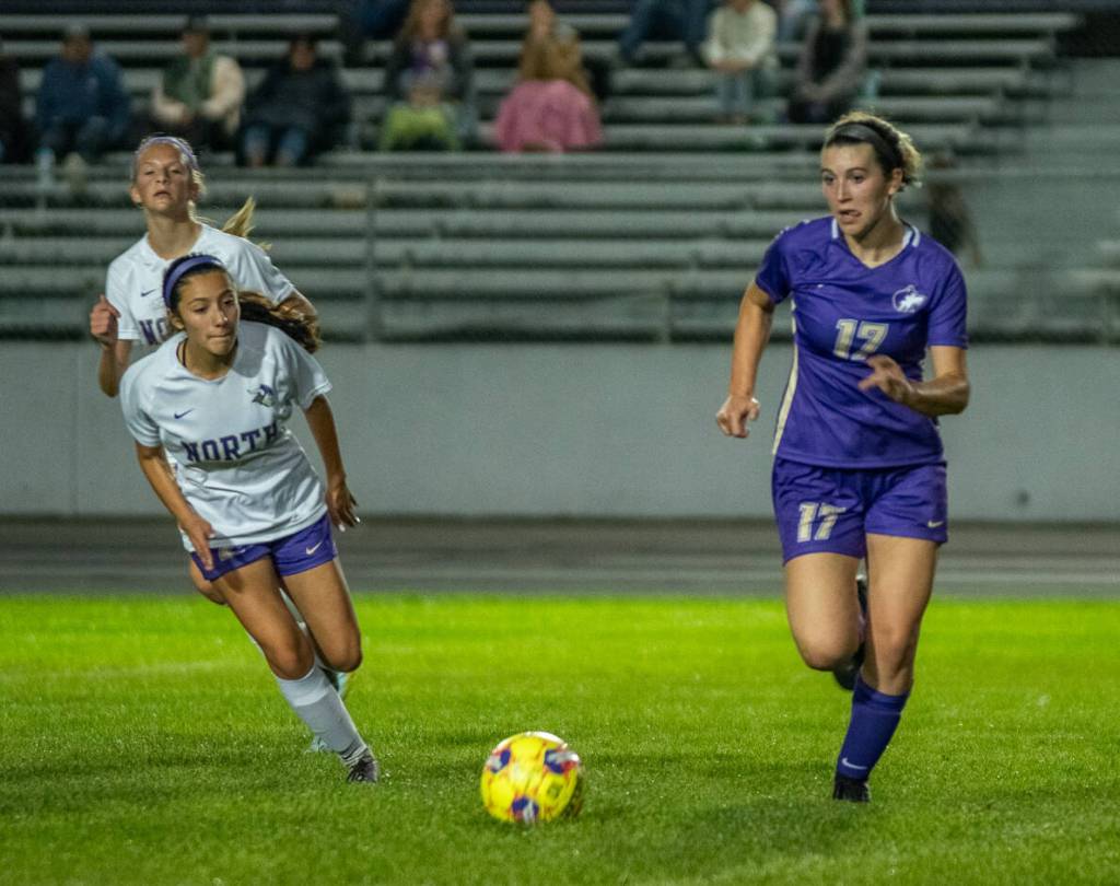 Sequim Gazette photo by Emily Matthiessen / Sequims Kaia Lestage, right, advances the ball in an Olympic League showdown with North Kitsap on Sept. 21.