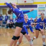 As teammates Sydney Clark, center, and Arianna Stovall, right, look on, Sequims Rose Gibson goes up for a hit in the Wolves Sept. 21 match-up with North Kitsap.