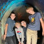 Sequim Gazette photo by Matthew Nash/ Fourth-graders, from left, Wade McCarthey, Willem Van de Weghe, Theodore Wood and Jude Reno check out the inside of Fin, a giant interactive salmon with the North Olympic Salmon Coalition during the Dungeness River Festival.