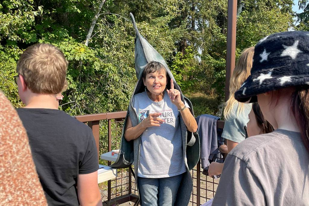 Sequim Gazette photo by Matthew Nash/ At the Dungeness River Festival, volunteer Connie Barron speaks to school children about the different salmon species and how to keep the river healthy.