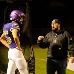 Sequim Gazette photo by Michael Dashiell / Cody Buckmaster, Sequim High football special teams coach (right), talks with Jack Henninger during an Oct. 13 league match-up with North Mason.
