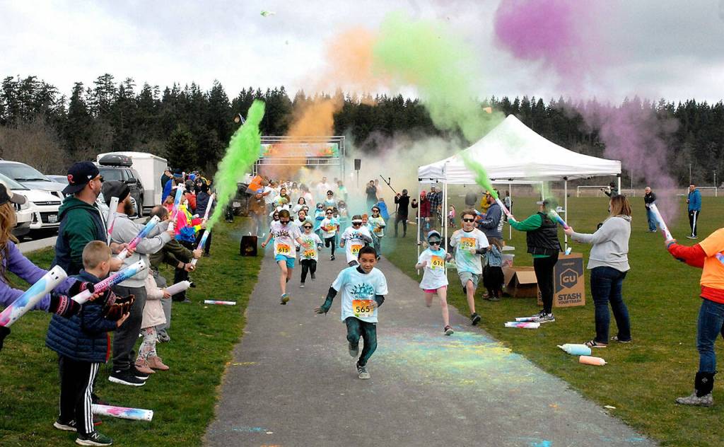 File photo by Keith Thorpe/Olympic Peninsula News Group
Children run beneath a volley of tempera paint cannons at the start of the 1k Sun Fun Color Run at Carrie Blake Community Park in 2020. Registration for the 2024 event is now open.