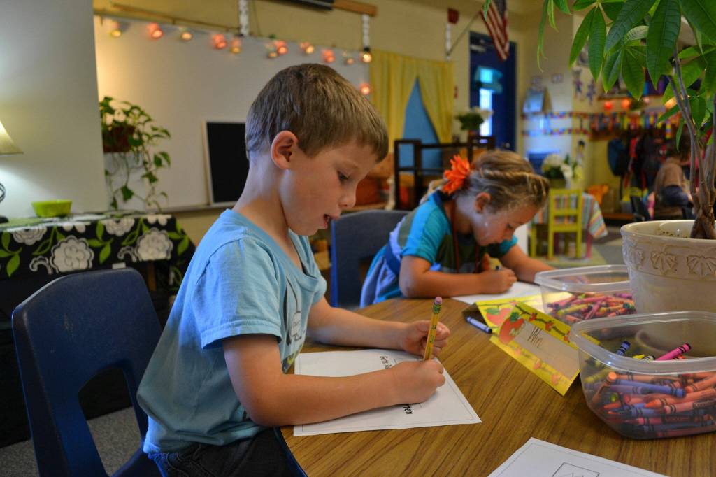 Sequim Gazette file photo by Matthew Nash/ Win Jones, 5 and the time, does a writing exercise in 2011 on their first day of kindergarten.