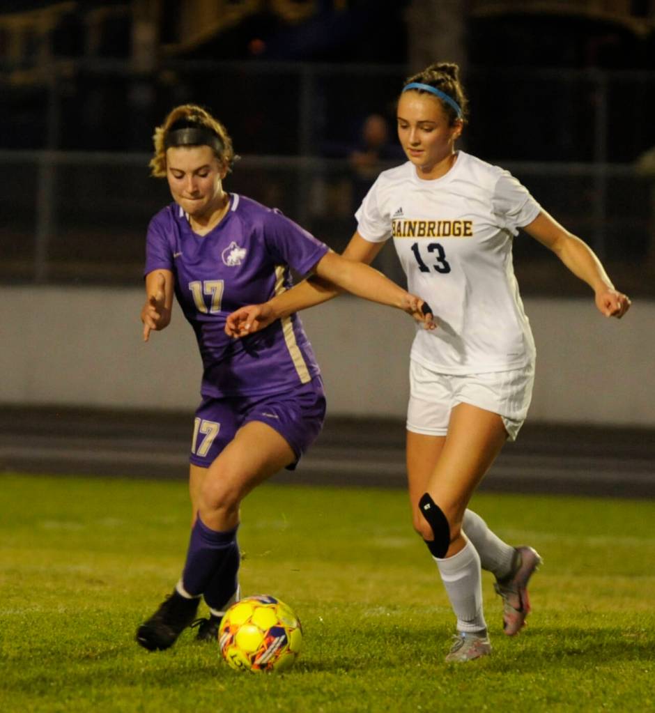 Sequims Kaia Lestage, left, battles with Bainbridges Elizabeth Stuyvesant in the first half of a Sept. 26 Olympic League showdown.