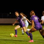 With teammate Jennyfer Gomez (10) looking on, Sequims Olive Bridge seeks an open teammate in the second half of a Sept. 26 Olympic League home game against Bainbridge.