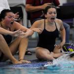Sequim Gazette photo by Michael Dashiell / Sequims Melia Nelson, left, and Ava Shinkle cheer on teammate Annie Ellefson in the 100 breaststroke as the Wolves take on Bremerton at home on Sept. 27.