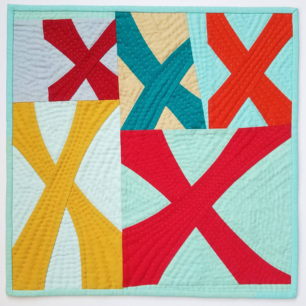 Art courtesy of Marla Varner / Xes by Marla Varner, a participant in the Spinning Sewn Stories – Promulgate, Piece, & Ply exhibit hosted by the North Olympic Fiber Arts Festival.