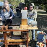 Michaela Christiansen, 14, left, and Pen DeBord, 14, both of Port Angeles, use a cider press to crush fresh apples into juice and pulp during Saturday's Applestock celebration in Sequim. The event, a benefit for several area charities, featured food, music, crafts and games in the orchard at Williams Manor B&B/Vacation Rental. Applestock 2023 beneficiaries were the Salvation Army Food Bank, Angel Tree Christmas, Coats for Kids and area food banks. (Keith Thorpe/Peninsula Daily News)