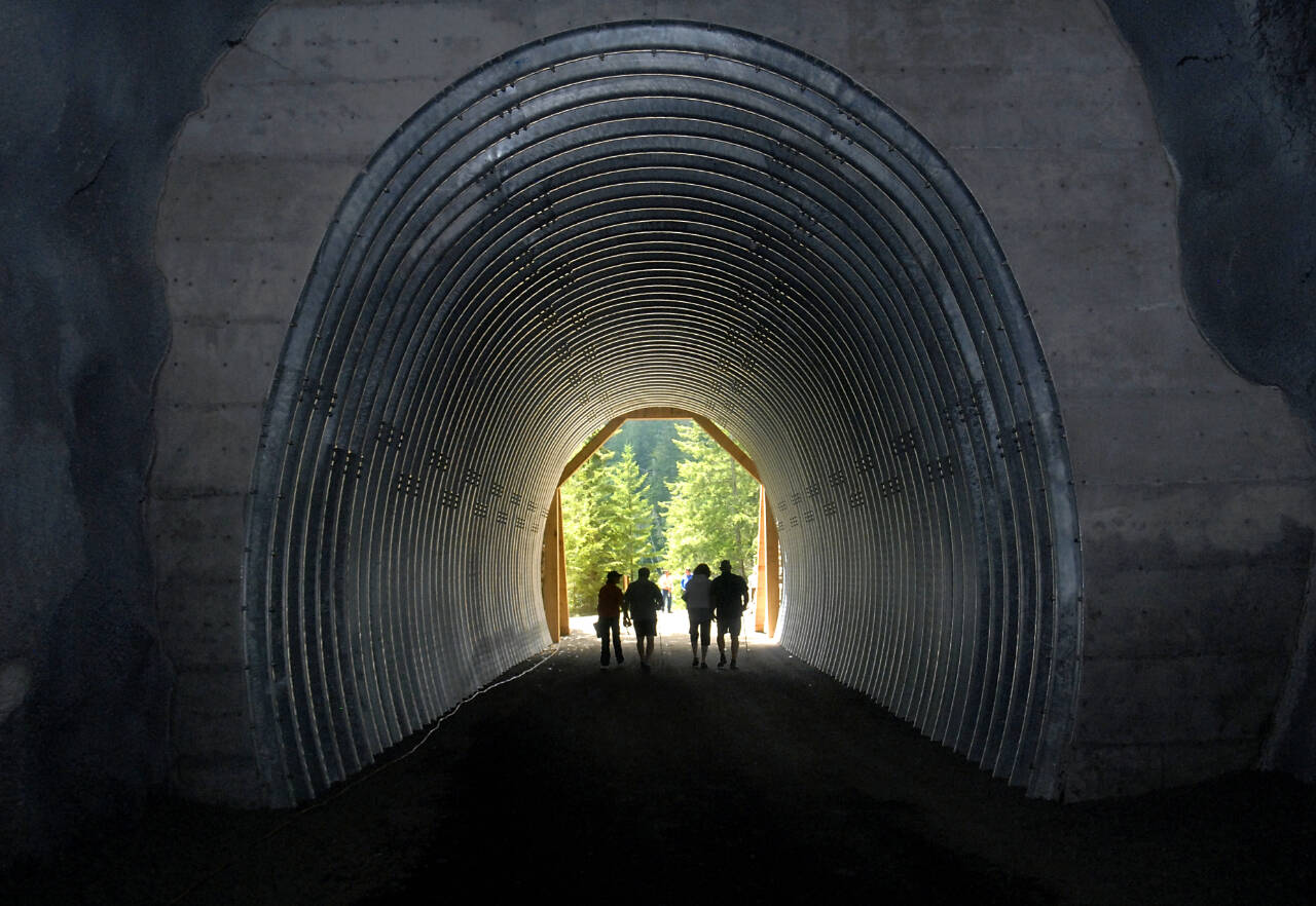 File photo by Keith Thorpe/Olympic Peninsula News Group / Visitors explore McFee Tunnel on the Spruce Railroad Trail along Lake Crescent in Olympic National Park — a section of the Peninsula-spanning Olympic Discovery Trail — in 2017. Clallam County commissioners will discuss their Six-Year Transportation Improvement Program for 2024-2029 on Oct. 18, which will include a 12-mile trail segment extension that will run between U.S. Highway 101 to the existing La Push trail along state Highway 110, also known as La Push Road.