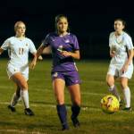 Sequim Gazette photo by Michael Dashiell
Sequims Raimey Brewer, center, passes to a teammate in the second half of the Wolves 4-0 home win over Kingston on Oct. 3. Looking on is Kingstons Savannah Lennette (11) and Katie Zehrung (18).
