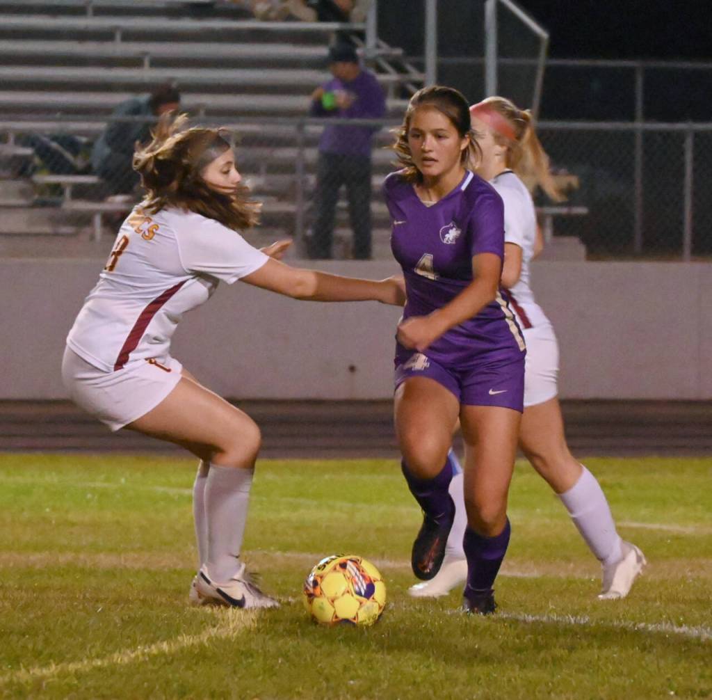 Sequim Gazette photo by Michael Dashiell / Sequims Raimey Brewer, center, drives into Kingston territory in the second half of the Wolves 4-0 home win over the Buccaneers on Oct. 3.