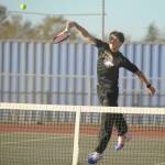 Sequim Gazette photo by Michael Dashiell / Sequims William Hughes hits an overhand shot as he and doubles partner Tom Laschet take on a Kingston team in No. 1 doubles play on Oct. 5 in Sequim.