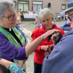 Sequim Gazette photos by Matthew Nash
Pastor Desi Larson blesses Abby the dog as owner Joel Swenning and church member JoAnn Sahs-Cavin, in middle, look on during a Blessing of the Animals ceremony on Oct. 8 at Trinity United Methodist Church.