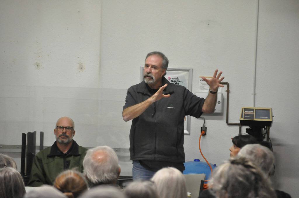 Sequim Gazette photo by Matthew Nash/ Fire commissioner Mike Mingee with Clallam County Fire District 3 tells a crowd of more than 30 people on Oct. 9 that no decision has been made to sell Lost Mountain Station 36. He and other fire commissioners agreed that they wanted to see a volunteer firefighter recruiting effort before making a decision on the station.