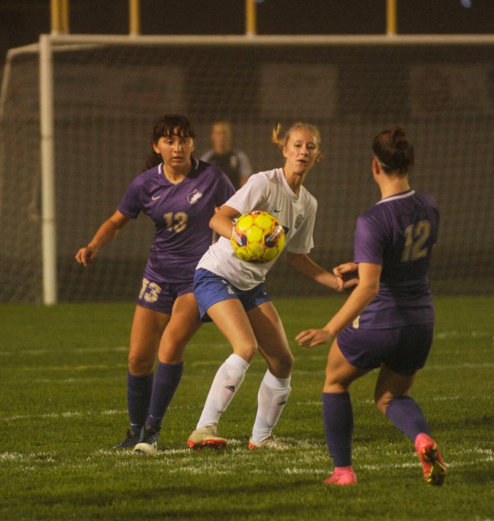 Sequim Gazette photo by Michael Dashiell / Sequims Amara Gonzalez, left, and Olive Bridge keep an eye on Olympics Kaydentze Lloyd in the first half of a 1-0 win over the visiting Trojans on Oct. 12.