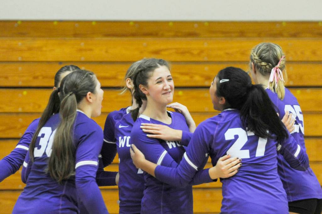 Sequim Gazette photoS by Michael Dashiell
Sequim teammates congratulate Rose Gibson, center, after scoring a point in the third set of an Oct. 10 sweep of Port Angeles.