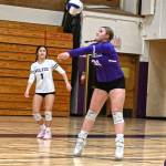 Sequim Gazette photo by Michael Dashiell / As teammate Tiffany Lam, left, looks on, Sequims Ashton Reichner returns a Port Angeles serve as the Wolves take on  and beat  the Roughriders in an Oct. 10 league match-up.