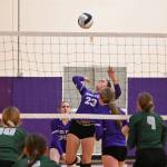 Sequim Gazette photo by Michael Dashiell / As Sequim teammates look on, Kenzi Berglund (center) rises up for a spike in an Oct. 10 Olympic League match against Port Angeles.