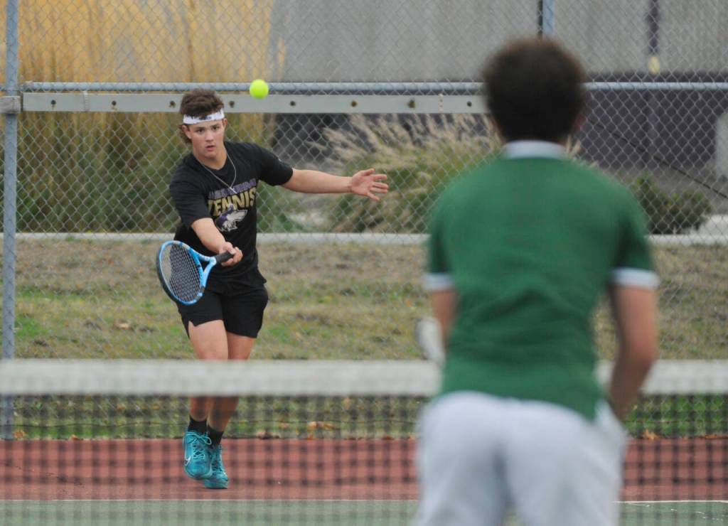 Sequim Gazette photos by Michael Dashiell
Sequims Lincoln Bear, left, returns a volley as he takes on Port Angeles Carter Gunderson on Oct. 11 in Sequim. Bear won a 7-6 (7-2) first set tiebreaker and went on to win the match. He went 2-0 in singles play last week.