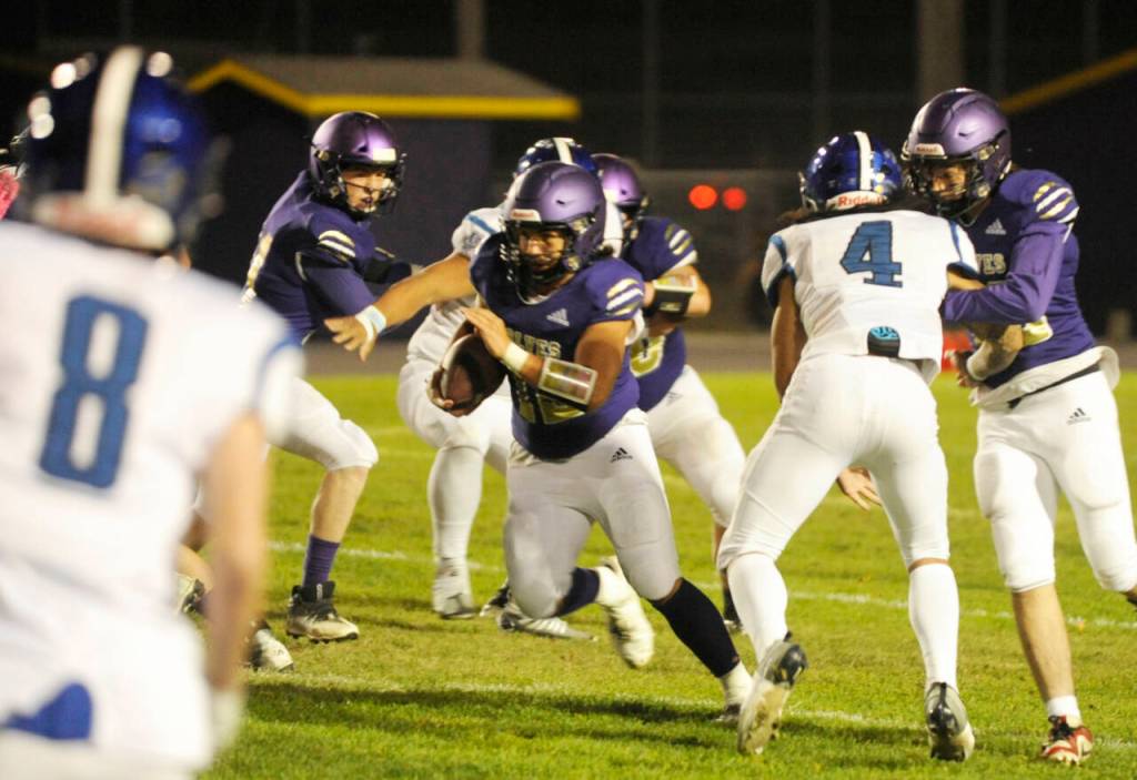Sequim Gazette photo by Michael Dashiell / Sequims Liam Wiker, center, finds a gaping hole in the North Mason defense in the second half of Sequims 36-0 win on Oct. 13. Wiker led the team with 106 yards on 14 carries.