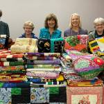 Sequim Gazette photo by Matthew Nash
Volunteers with Sunbonnet Quilt Clubs Community Quilts group donate 125 quilts to Sequim Community Aids Toys for Sequim Kids effort. Pictured for the donation were, from left, Mary Bess, Carmen OBrien, Kathy Suta, president of Sequim Community Aid, Bonnie Cauffman, and Patricia Wood.