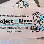 Sequim Gazette photo by Matthew Nash/ Project Linus quilts include a tag with the signature Peanuts character.