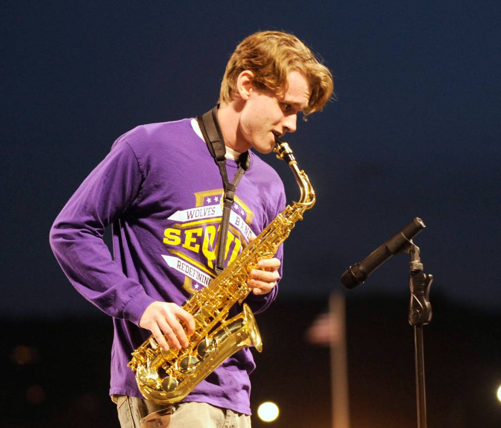Sequim High senior Anton Himillsson plays a saxophone solo rendition of the Star-Spangled Banner for the 2023 Homecoming crowd just prior to SHSs football game on Oct. 13.