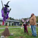 Sequim Gazette photo by Matthew Nash/ 
Josh Henning, with his grandson Rylee Robinson admire a witch that is activated by motion sensors.