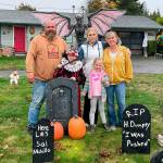 Sequim Gazette photo by Matthew Nash/ 
The Henning family, from left, Josh Henning, grandson Rylee Robinson, daughter Abby Henning, niece Clara Cergoli, and Ruby Henning stand in their family graveyard in front of their Old Olympic Highway home where theyve decorated for 14-plus years for Halloween and Christmas.